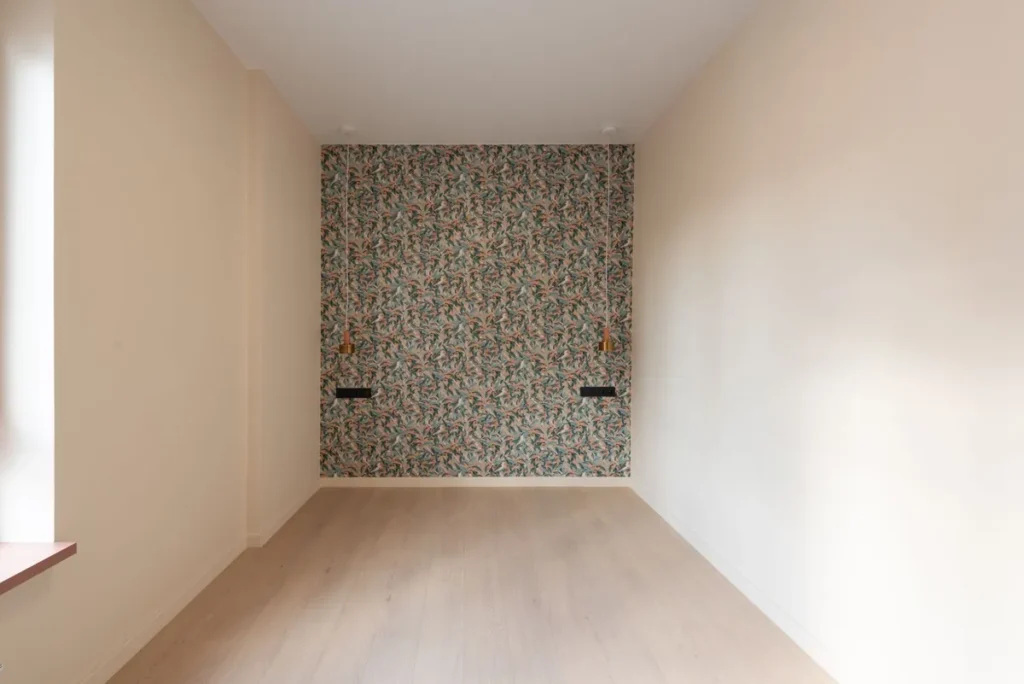 Empty apartment room with light plank flooring ready for the next tenant